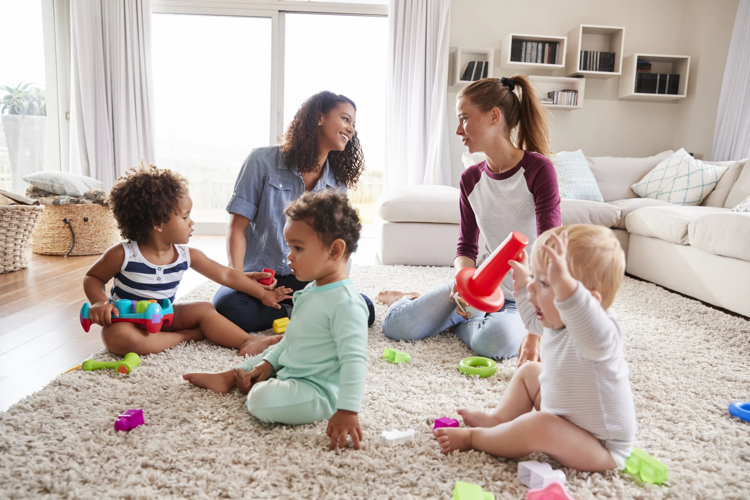 Two mothers meeting for a playdate with babies at Dream Childcare in Kent, WA, fostering a nurturing and social environment for children.