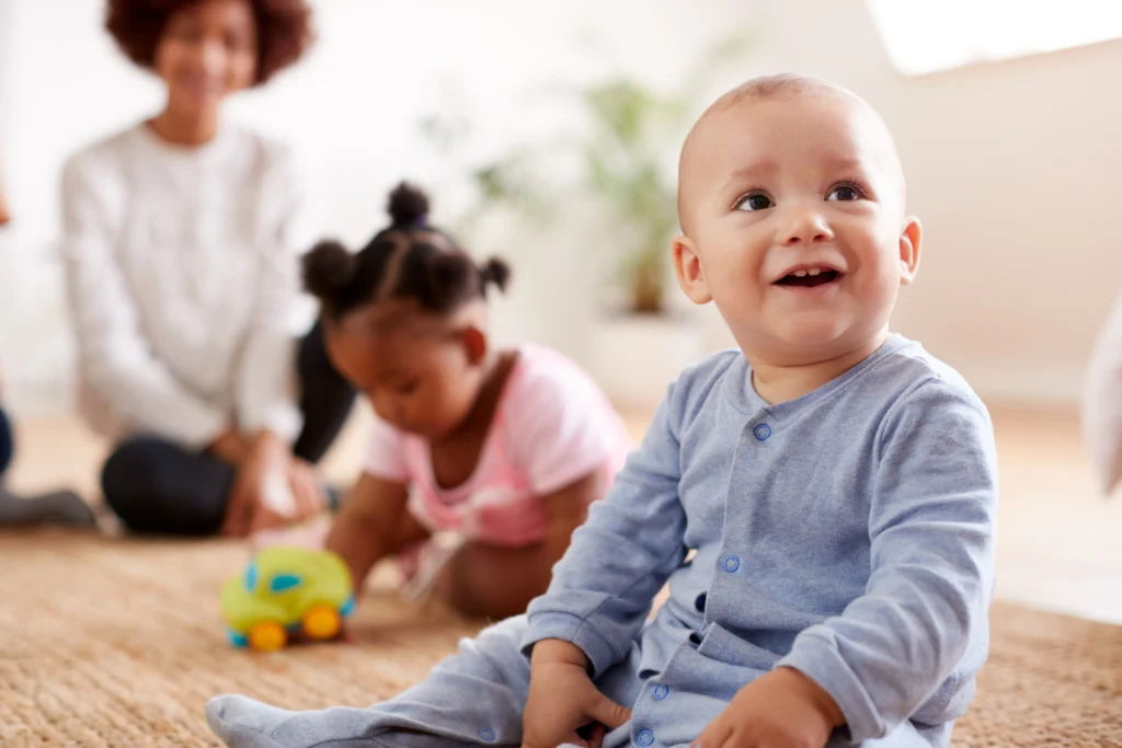 Babies and toddlers playing together at Dream Childcare in Kent, WA, promoting early childhood development in a fun, interactive setting.